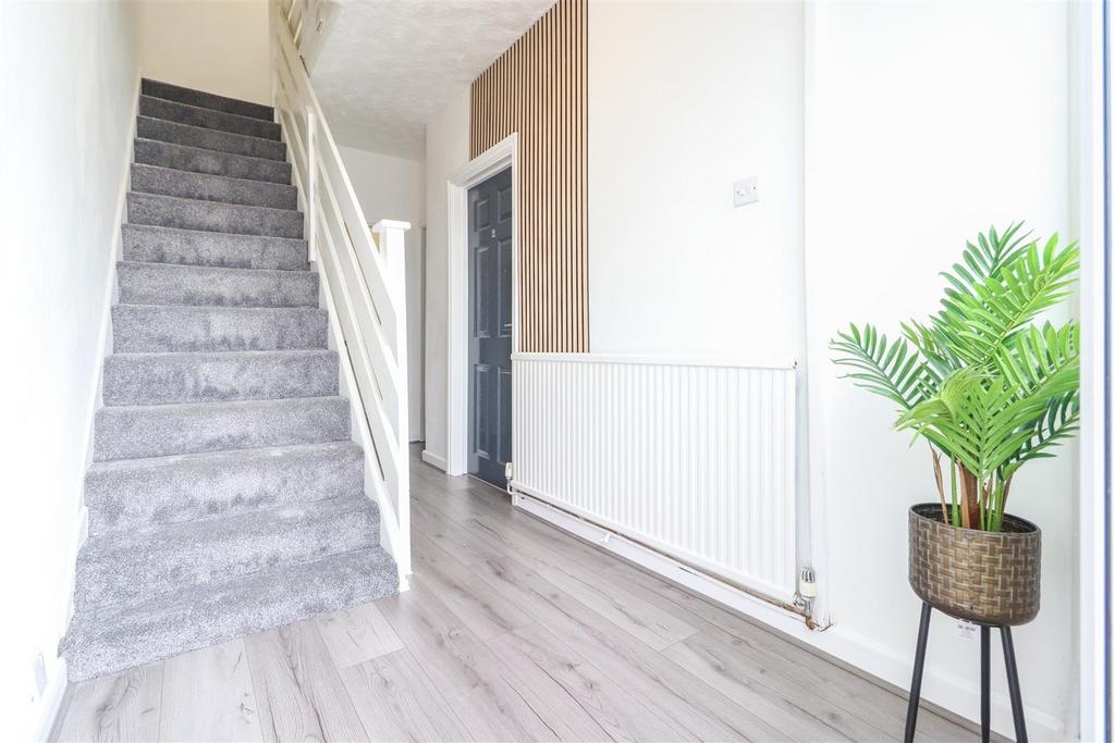 Bright, modern entrance hallway with light wood...