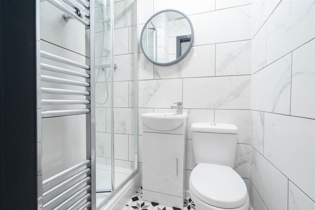 Bright modern bathroom with shower and tiles...