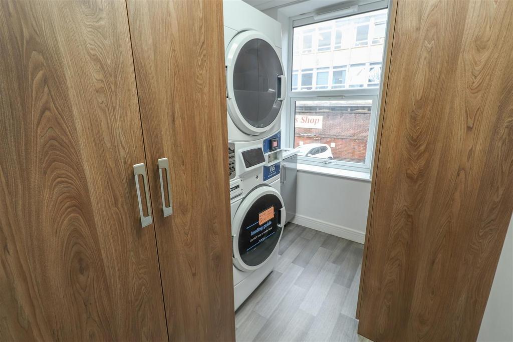 Utility area with washer-dryer and natural ligh...