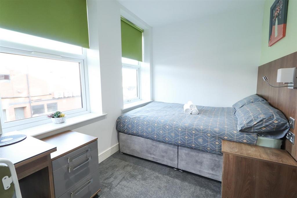Bright bedroom with large windows and study spa...