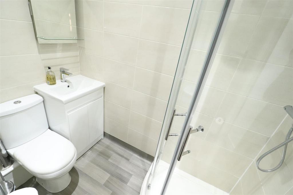 Bright modern bathroom with shower and vanity...