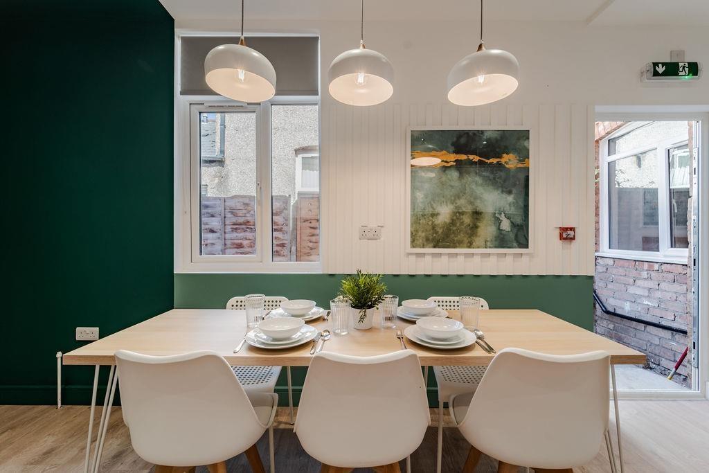 Bright dining area with modern table and seatin...