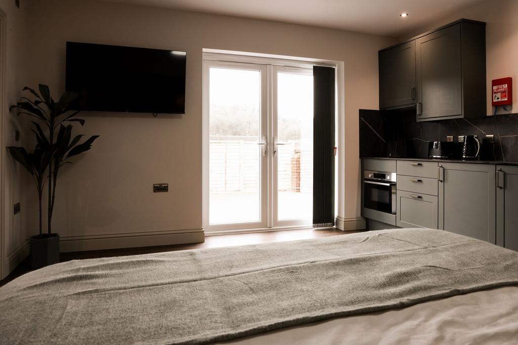 Bright bedroom with kitchenette and patio doors...