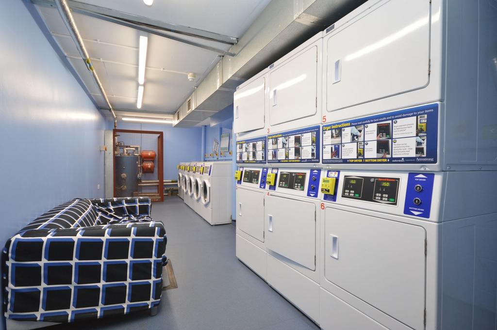 Bright communal laundry with seating...