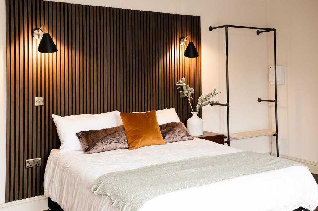 Stylish double bedroom with warm lighting...