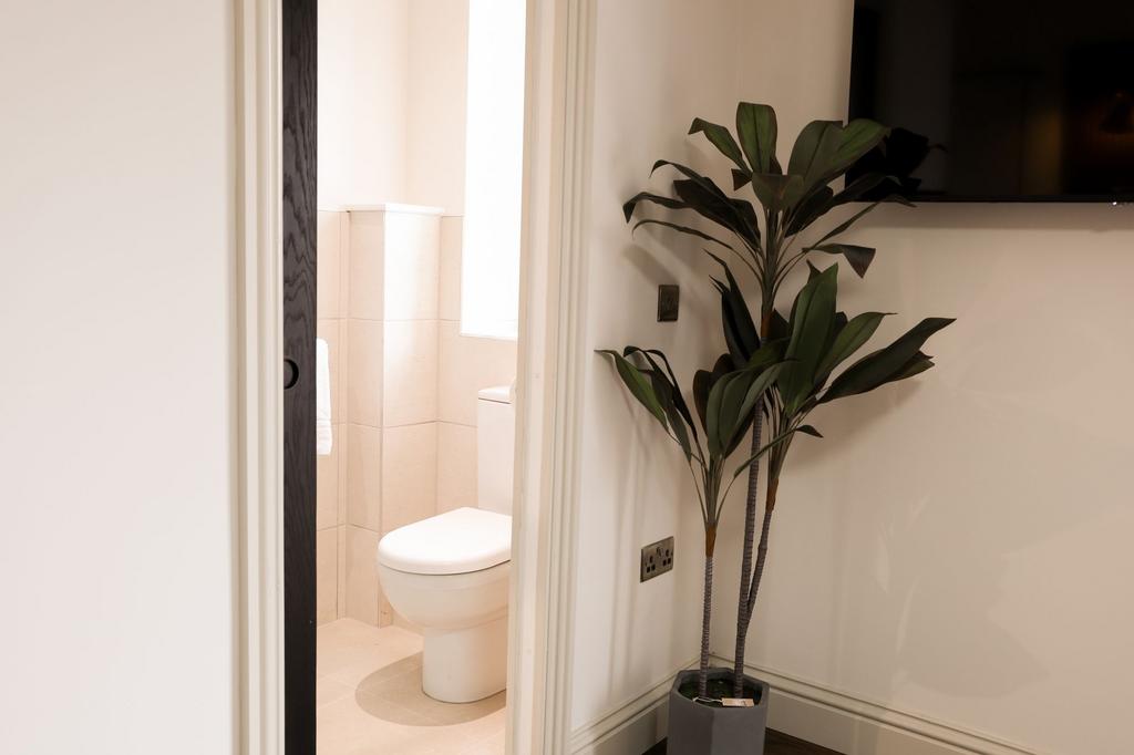 Neat modern WC with neutral tiles...