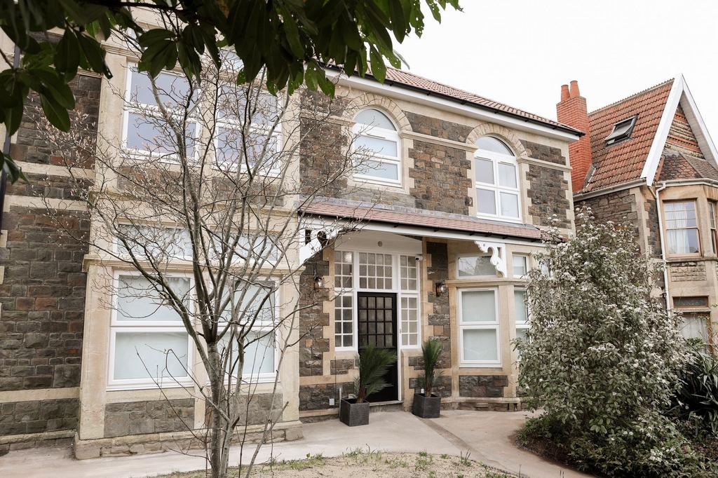 Attractive stone-front house with bay windows...