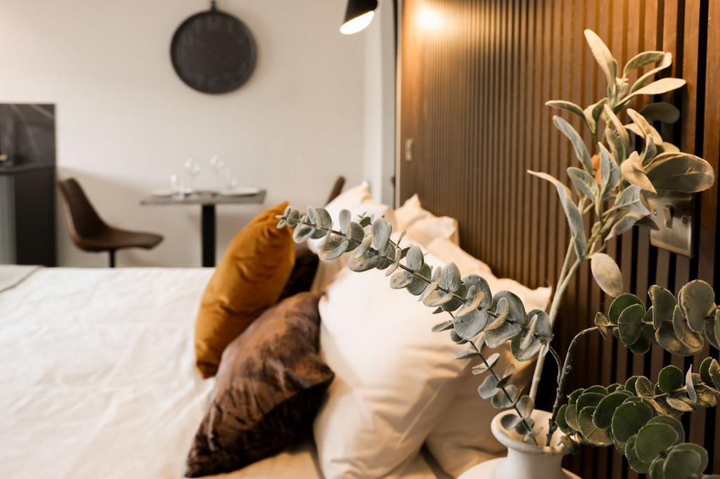 Stylish bedroom with textured headboard and sof...
