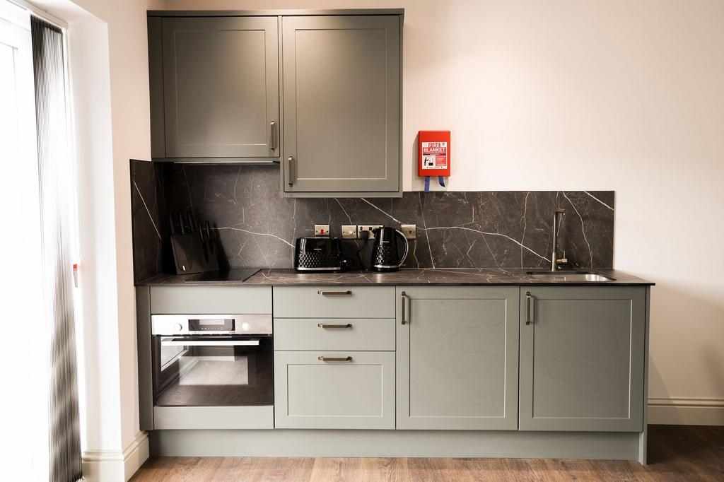 Modern compact kitchen with marble-effect workt...