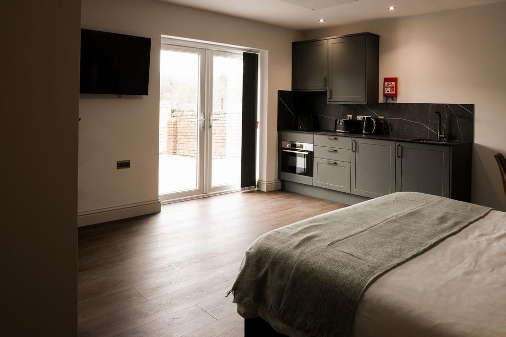Bright studio bedroom with kitchenette and pati...