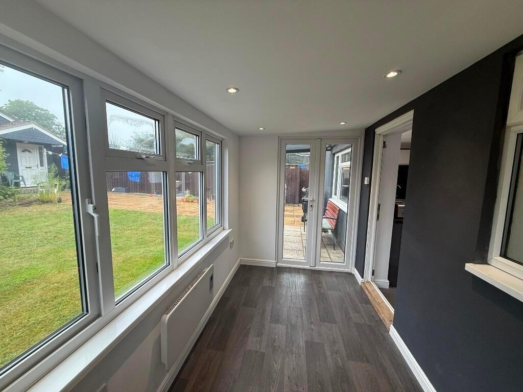 Bright, modern living area with a wall of large...