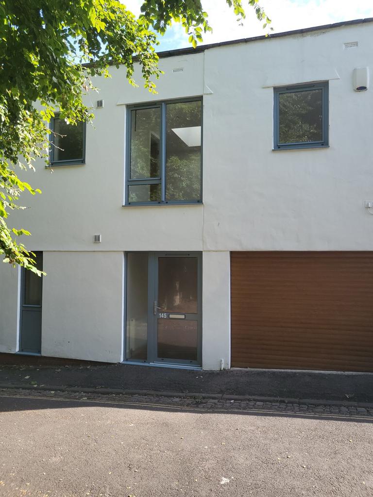 Modern two-storey white-fronted house with larg...