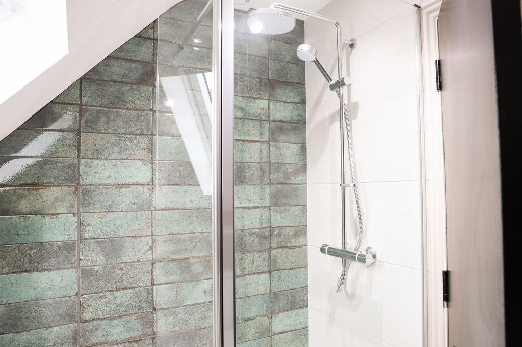 Modern tiled shower with rainfall head...