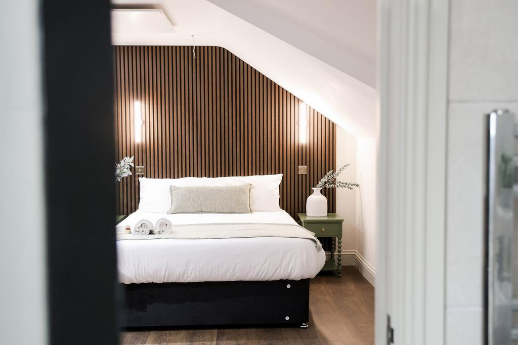 Stylish bedroom with feature wood slat wall...