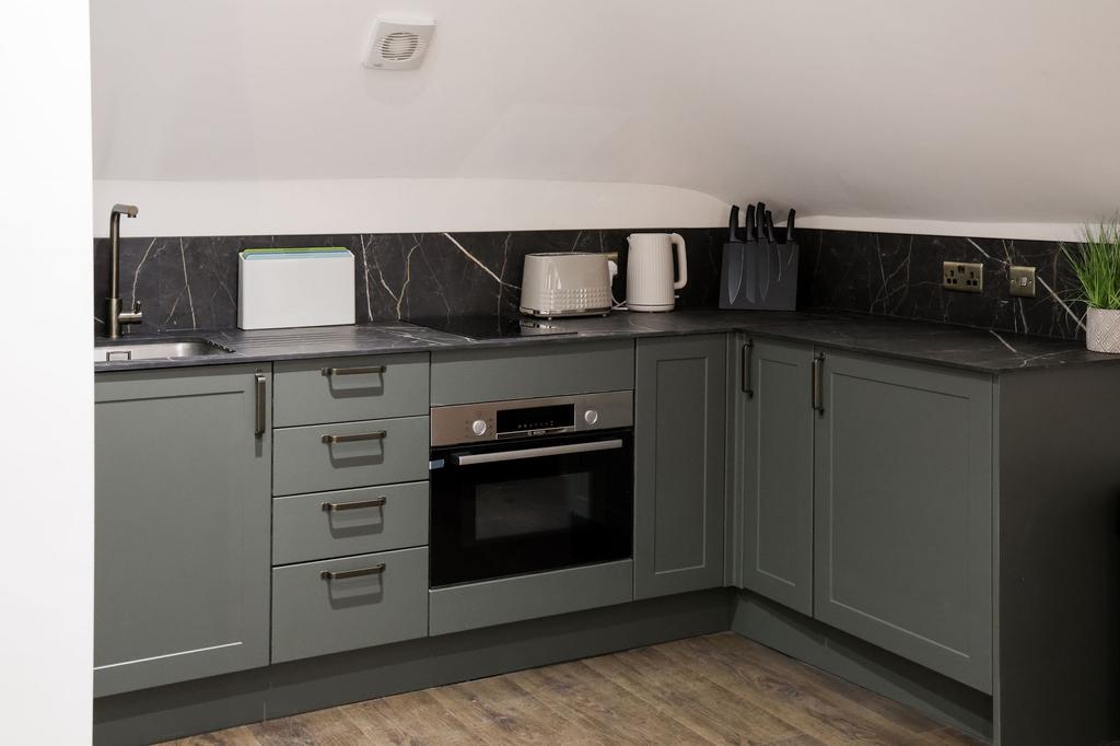 Modern fitted kitchen with integrated oven...