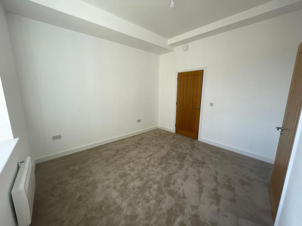 Bright, freshly decorated bedroom with neutral ...