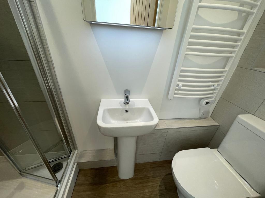 Modern compact bathroom with a corner shower, p...