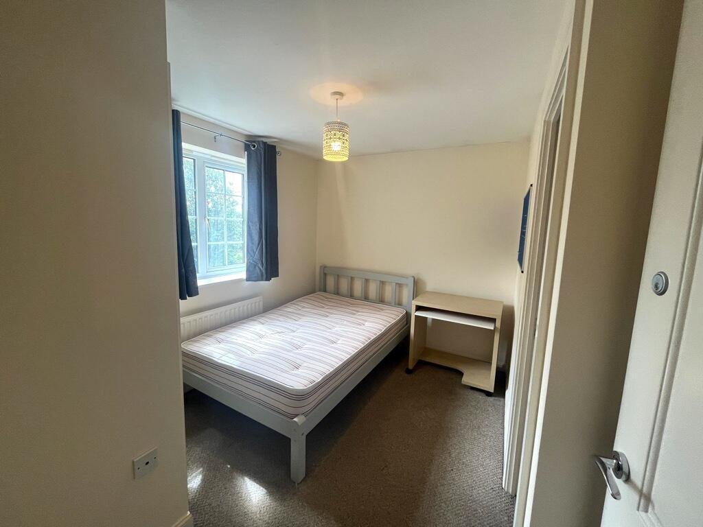 Bright, simply furnished double bedroom with a ...