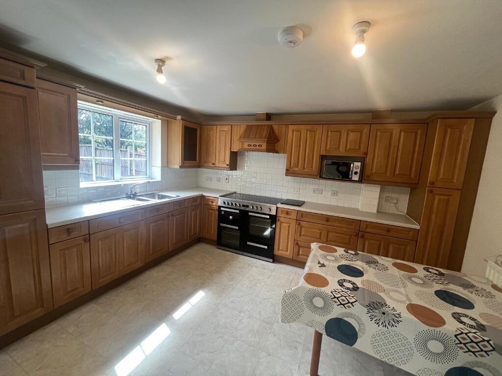 Spacious fitted kitchen with plentiful wooden c...