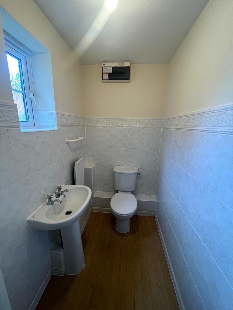 Neat and well-maintained WC with classic white ...
