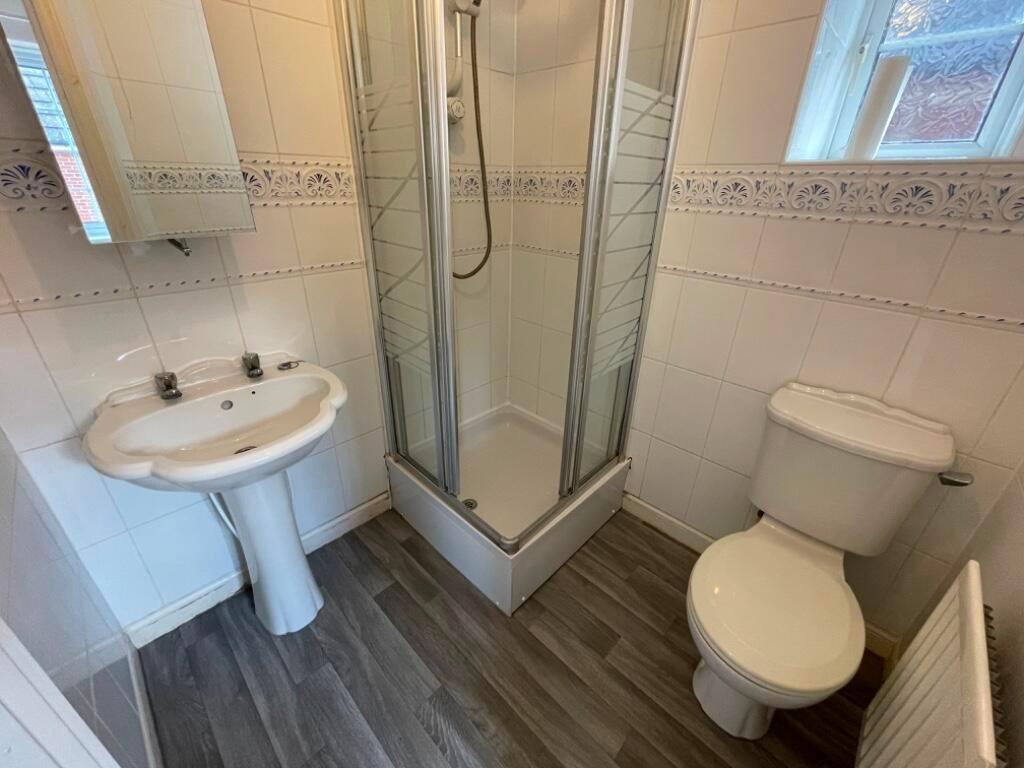 Bright, well-maintained bathroom with a corner ...