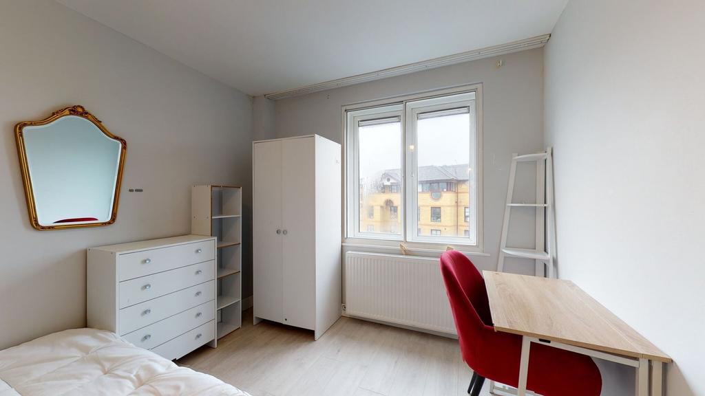 Bright, neatly presented bedroom with a large w...