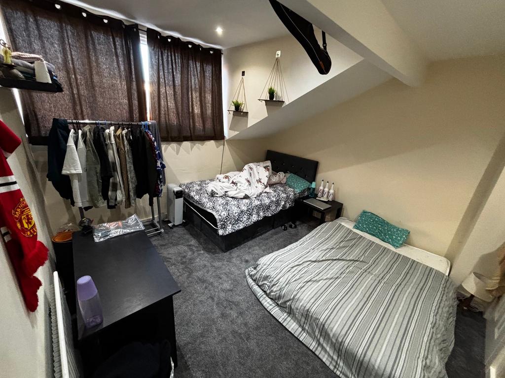 Bright, carpeted double bedroom with two beds, ...