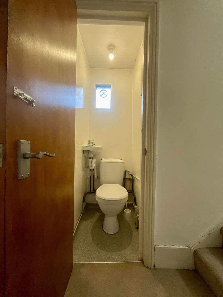 A clean and functional bathroom with a toilet, ...