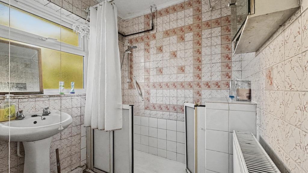Bright bathroom with large window and classic t...