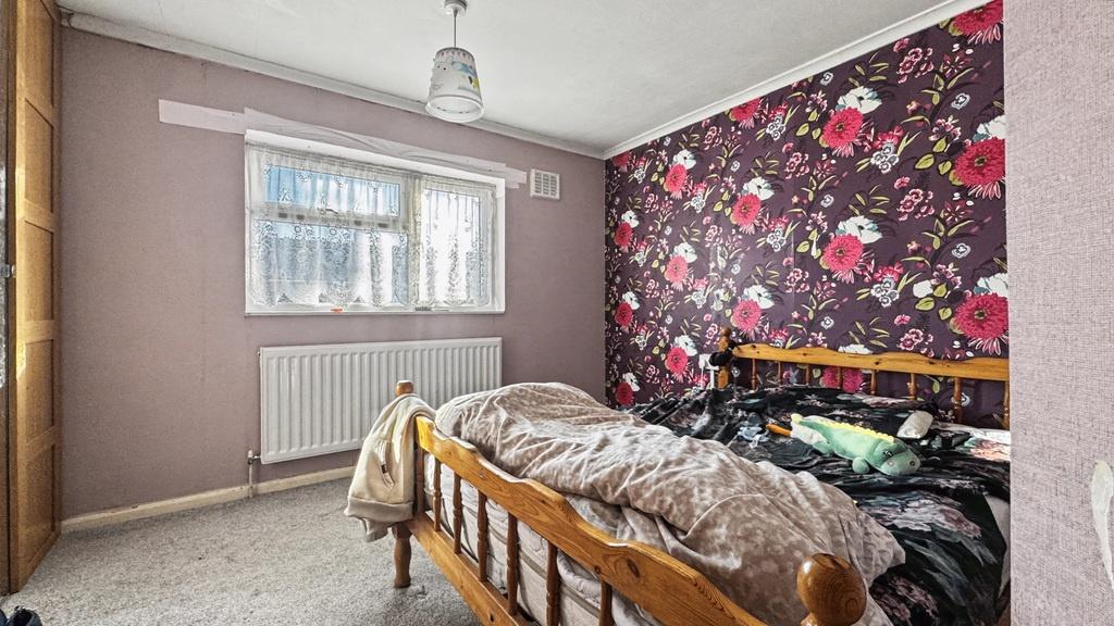 Cosy bedroom with bold floral feature wall...