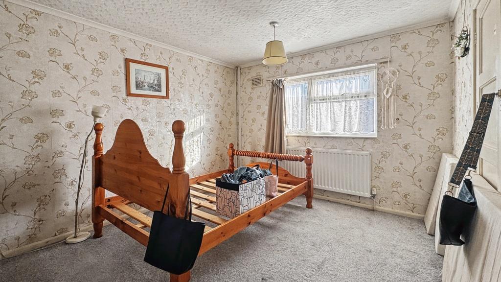 Bright double bedroom with traditional wooden b...