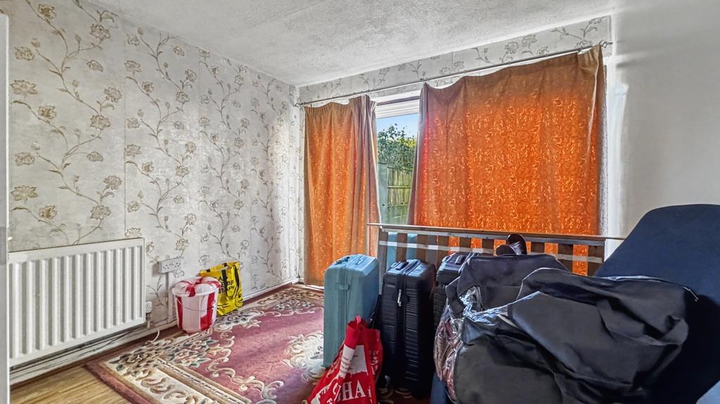 Cozy bedroom with patterned wallpaper and windo...