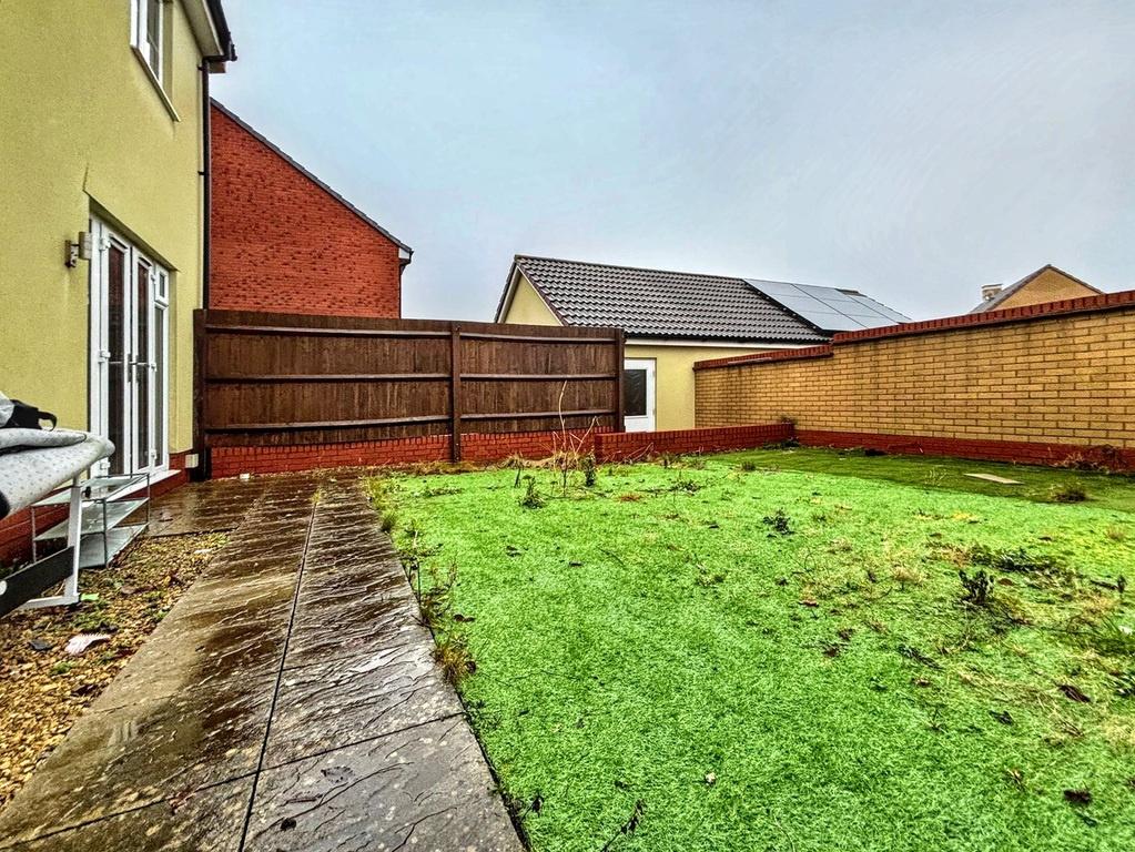 Sunny private rear garden with a paved patio pa...