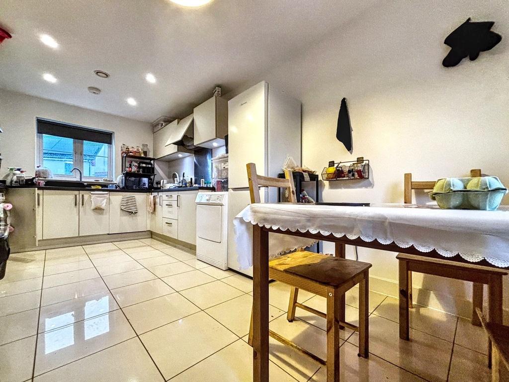 Bright, modern kitchen with tiled floors, plent...