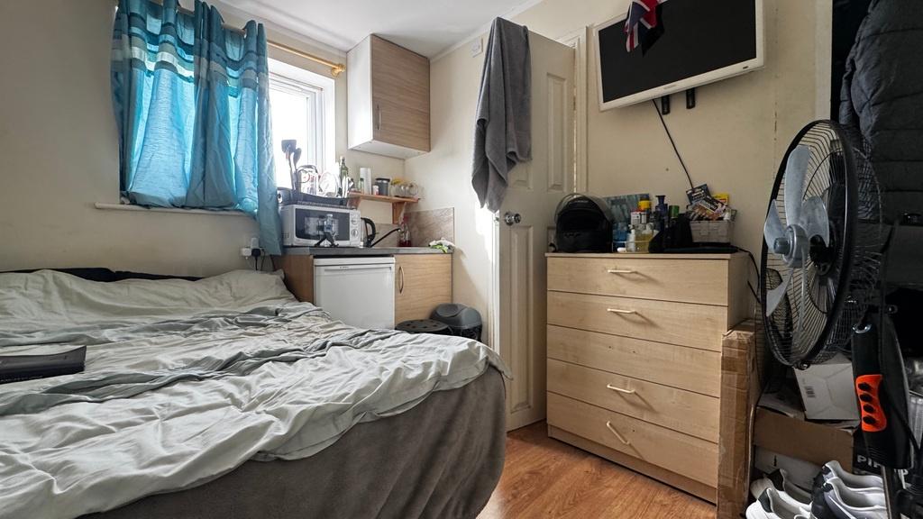 Cozy bedroom with a comfortable single bed, bui...