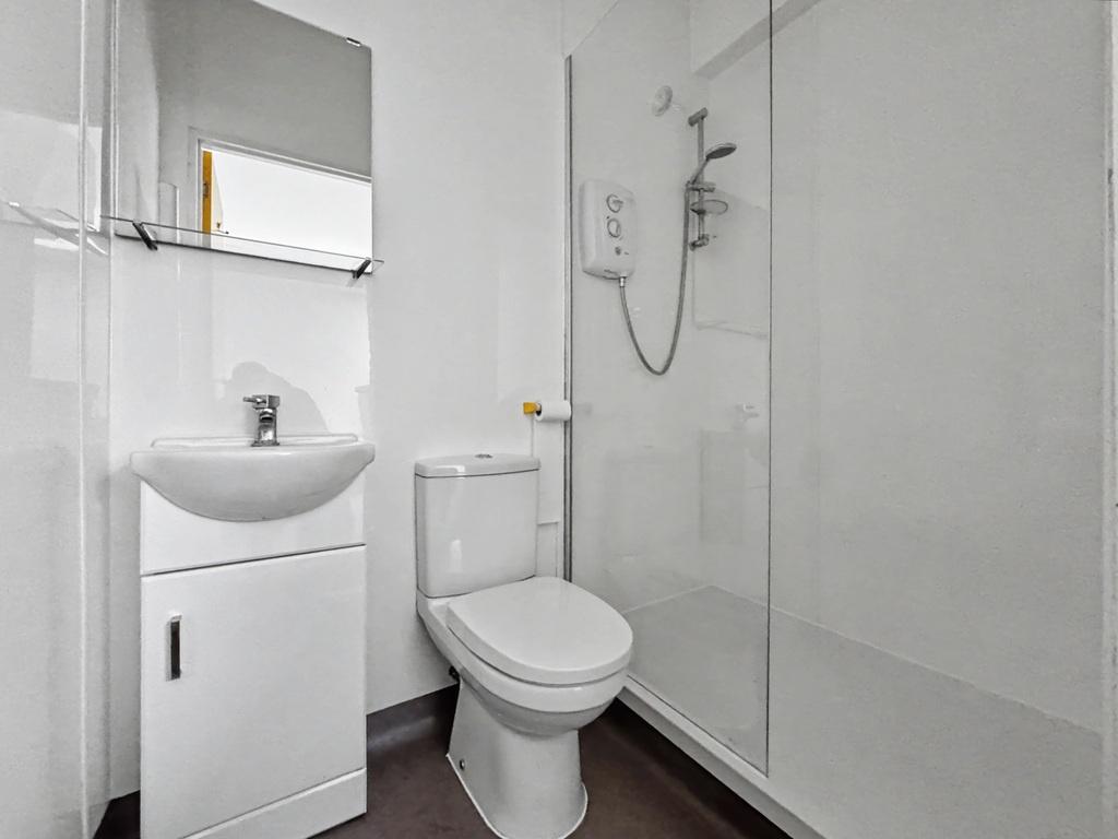 Bright, modern bathroom with a walk-in shower, ...