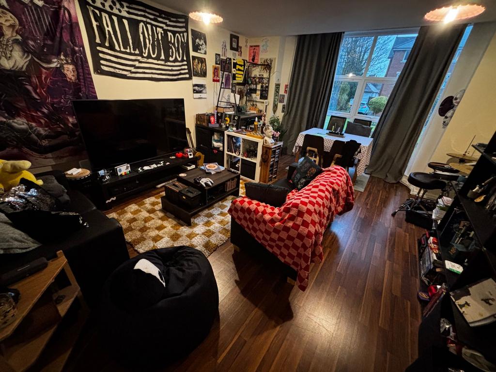 Bright, characterful living room with large win...