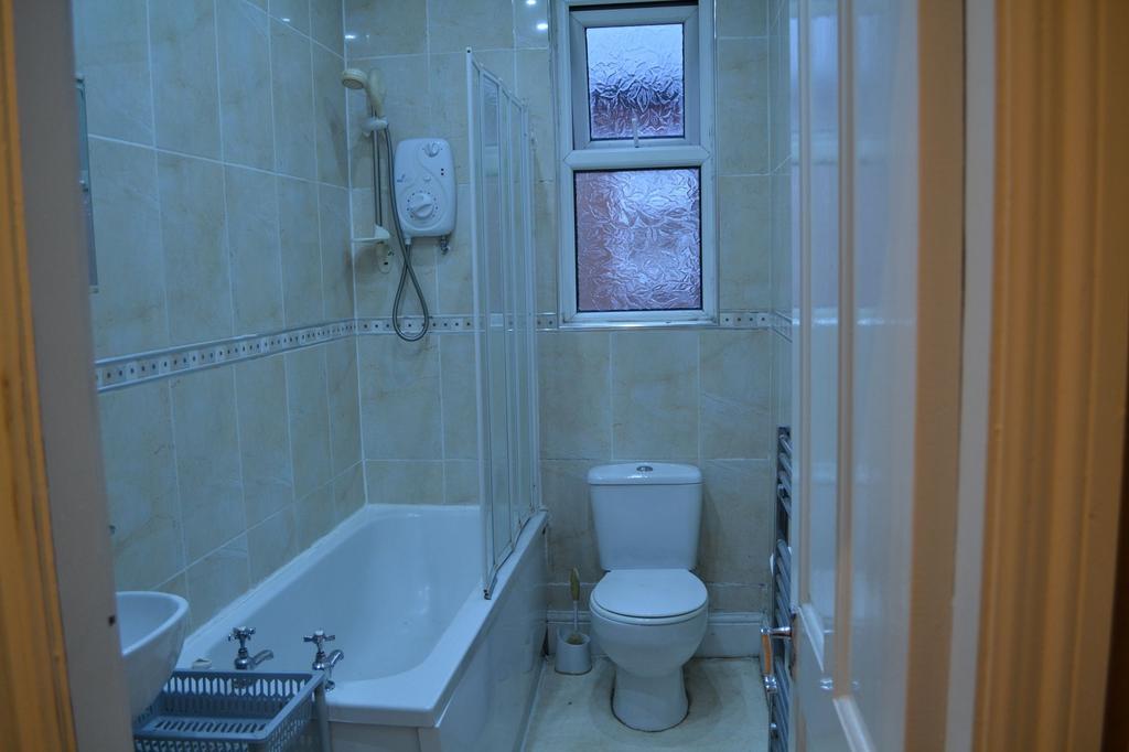 A clean and functional bathroom featuring a bat...