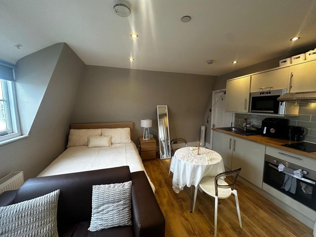 Bright, modern studio with a comfortable double...