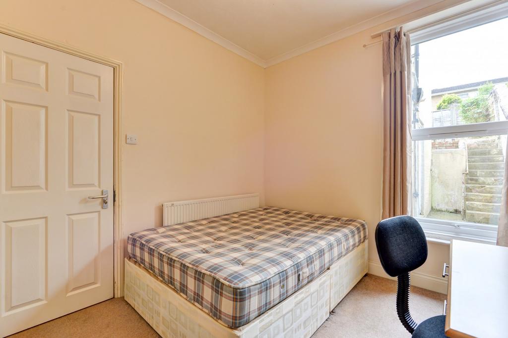 A welcoming student bedroom featuring a comfort...