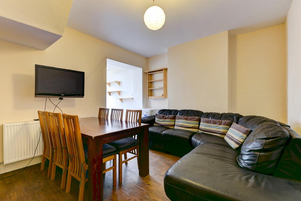 A spacious and well-lit living room featuring a...