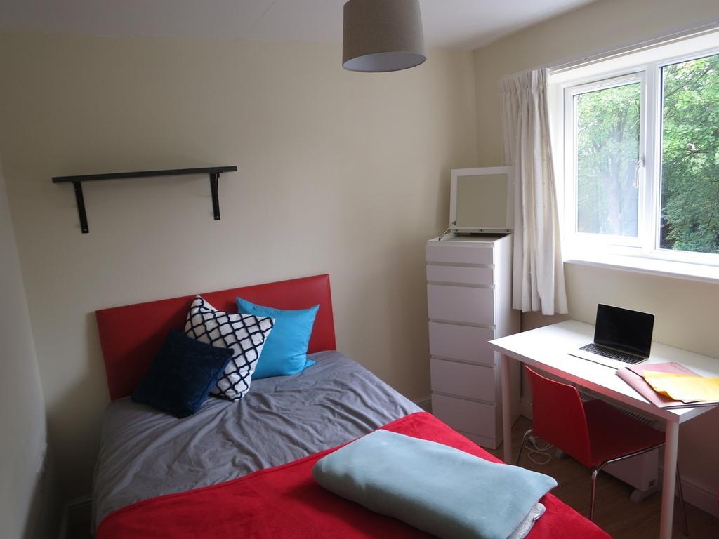 A bright and cozy double bedroom with modern de...