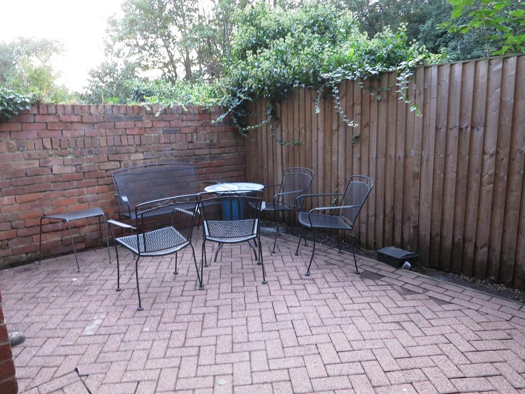 A lovely garden area with a cozy seating arrang...