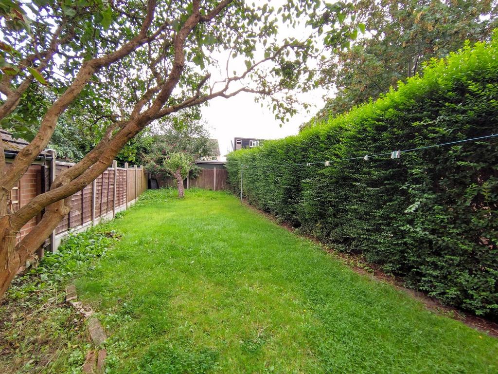 Private lawn with mature hedges and trees...