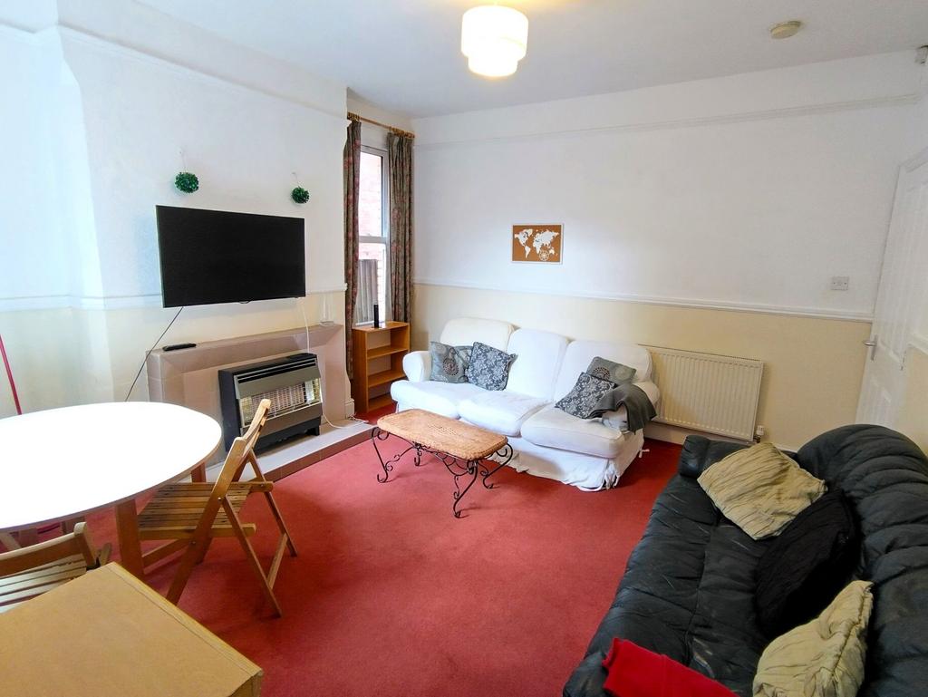 Bright furnished living room with seating and T...