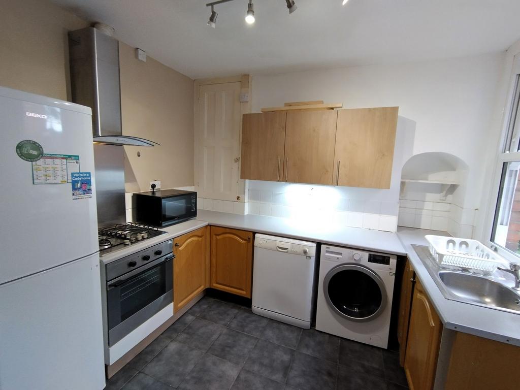 Well-equipped kitchen with appliances and sink...