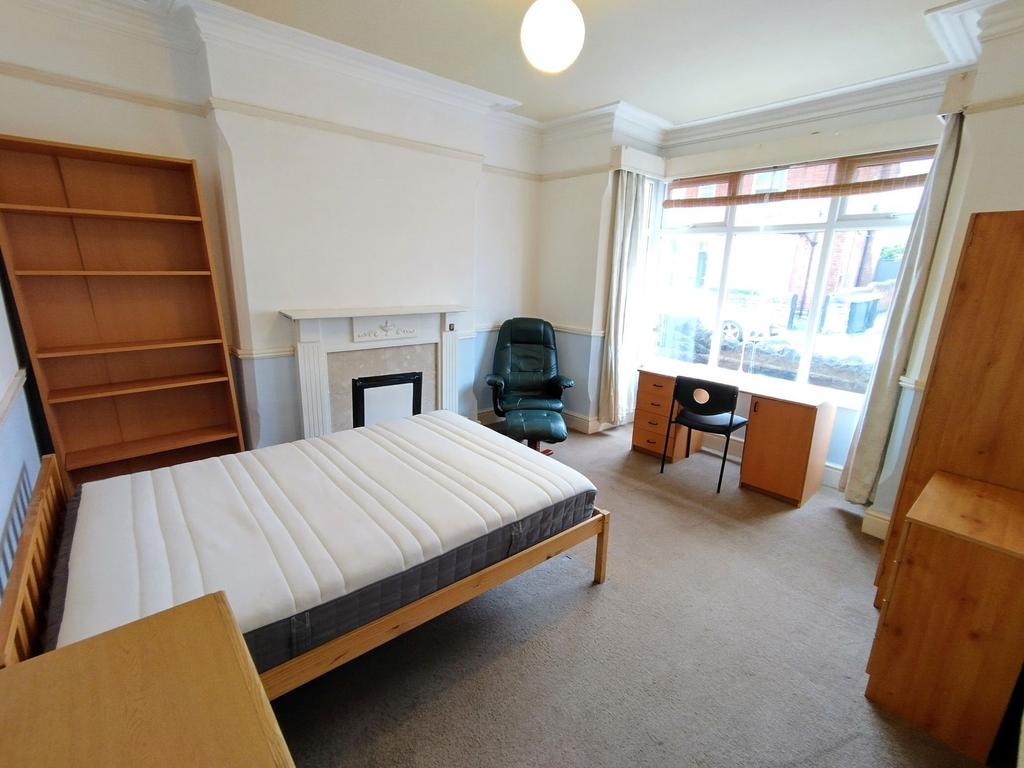 Bright furnished room with large window...