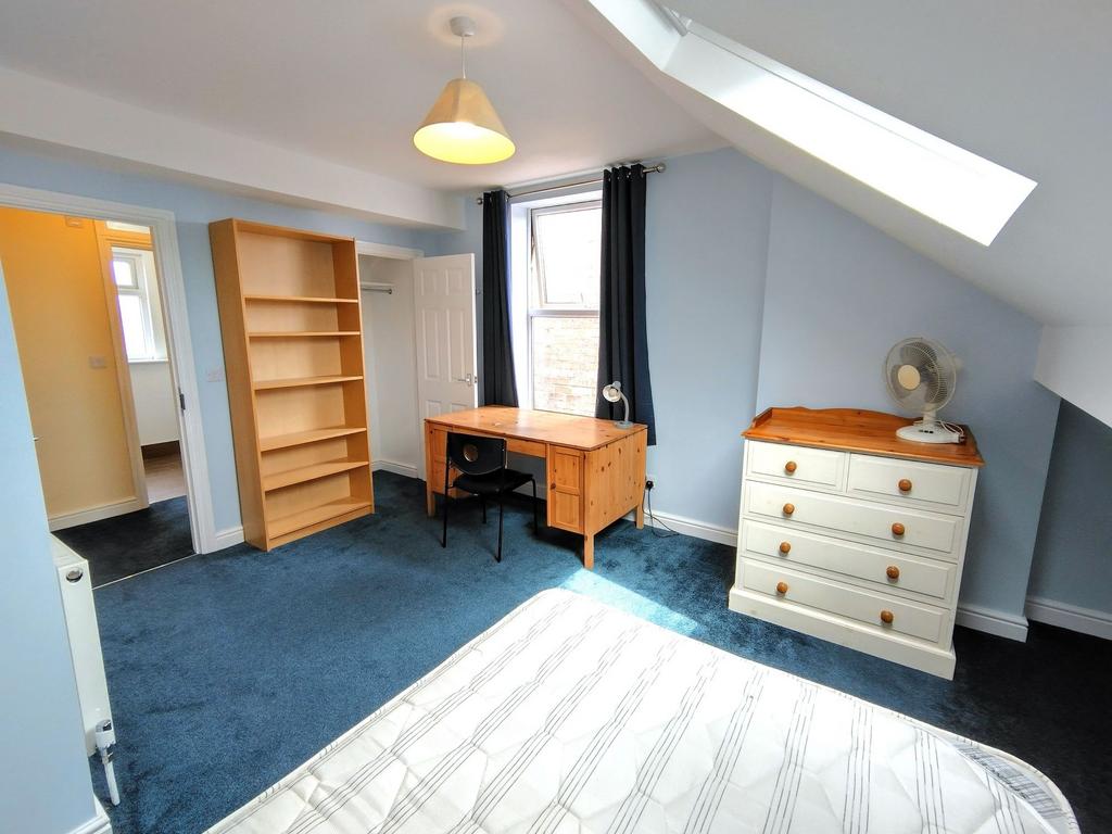 Bright, well-presented bedroom with a large win...