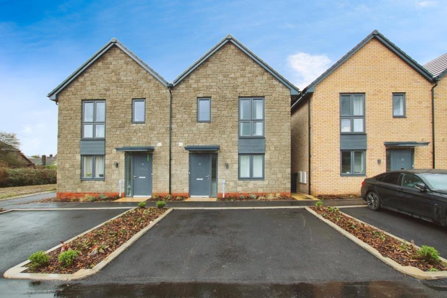 Modern semi-detached houses with neat stone and...