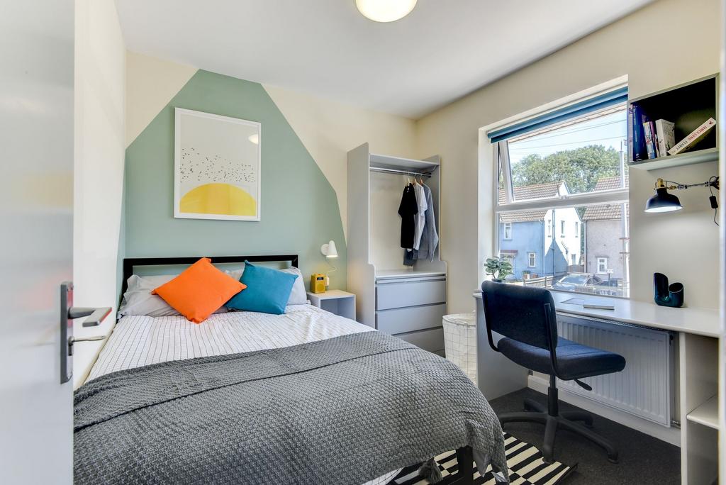 A cozy double bedroom featuring vibrant decor w...